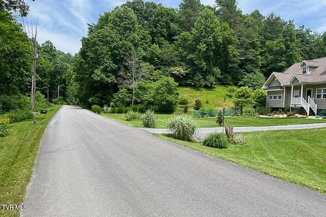view of road featuring a wooded view