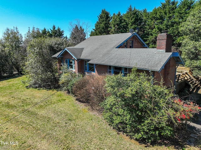 415 Fairgrounds Rd, Greeneville, TN 37745 - view of front facade featuring a shingled roof, a front yard, brick siding, and a chimney