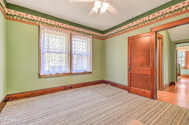 415 Fairgrounds Rd, Greeneville, TN 37745 - spare room with a textured ceiling, baseboards, a ceiling fan, and carpet floors