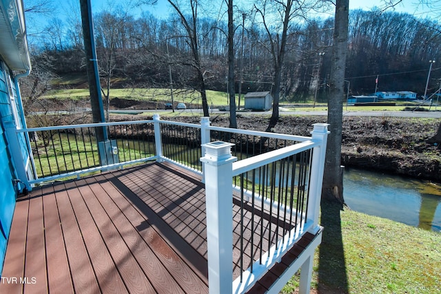 deck featuring a storage shed and an outdoor structure