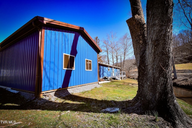 view of side of home with a lawn