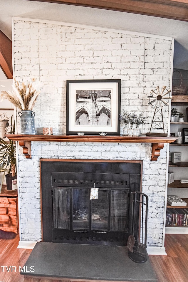 interior details with wood finished floors and a fireplace
