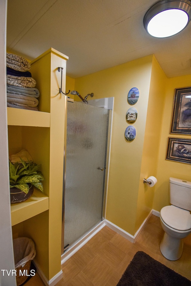 full bath with a shower stall, toilet, and baseboards