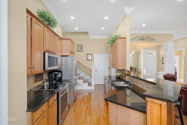 20324 Josh Allen Dr, Abingdon, VA 24211 - kitchen featuring crown molding, light wood-type flooring, appliances with stainless steel finishes, a kitchen breakfast bar, and a sink