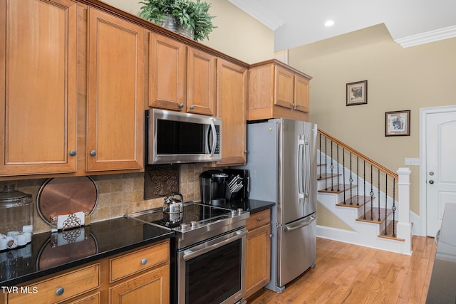 20324 Josh Allen Dr, Abingdon, VA 24211 - kitchen with light wood finished floors, tasteful backsplash, brown cabinets, and appliances with stainless steel finishes