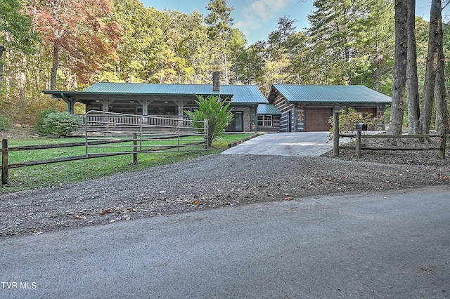 4610 Greene Mountain Rd, Greeneville, TN 37743 - view of front of house with a garage, stone siding, and metal roof