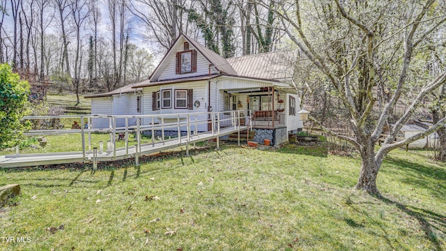 view of front facade featuring a deck and a front lawn