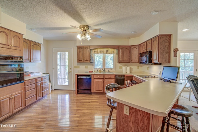 142 Laurel Acres Ct, Jonesborough, TN 37659 - kitchen featuring black appliances, a breakfast bar, ceiling fan, healthy amount of natural light, and a textured ceiling