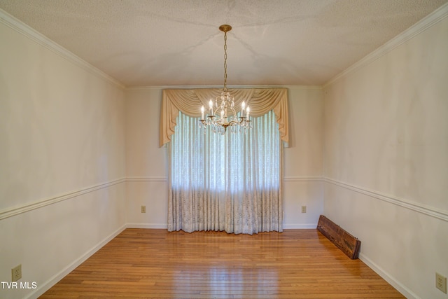 142 Laurel Acres Ct, Jonesborough, TN 37659 - unfurnished room with a chandelier, hardwood / wood-style flooring, a textured ceiling, and crown molding