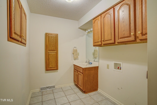 142 Laurel Acres Ct, Jonesborough, TN 37659 - washroom with cabinet space, hookup for a washing machine, light tile patterned flooring, and a textured ceiling