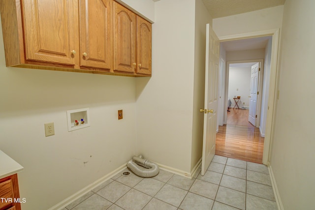 142 Laurel Acres Ct, Jonesborough, TN 37659 - laundry area featuring cabinet space, washer hookup, light tile patterned floors, and hookup for an electric dryer