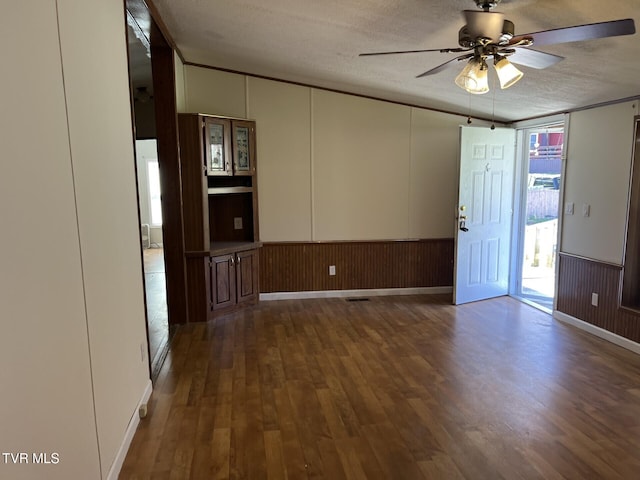 157 Power House Holw, Clintwood, VA 24228 - interior space featuring dark wood finished floors, a wainscoted wall, a textured ceiling, and ceiling fan