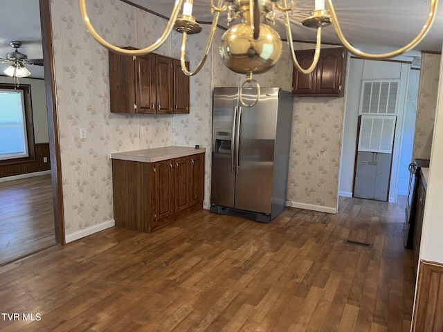 157 Power House Holw, Clintwood, VA 24228 - kitchen with wallpapered walls, stainless steel fridge with ice dispenser, light countertops, ceiling fan with notable chandelier, and dark wood-style floors