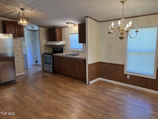 157 Power House Holw, Clintwood, VA 24228 - kitchen with wood finished floors, a wainscoted wall, under cabinet range hood, appliances with stainless steel finishes, and a notable chandelier