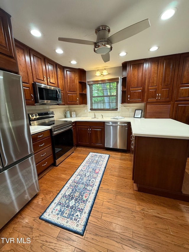 1209 Beechwood Dr, Johnson City, TN 37604 - kitchen with appliances with stainless steel finishes, open shelves, light countertops, decorative backsplash, and ceiling fan