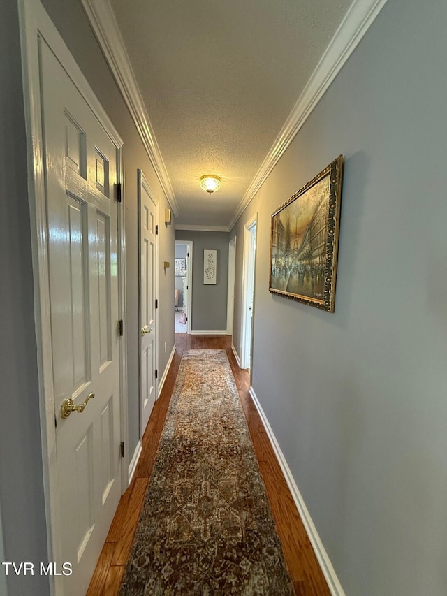 1209 Beechwood Dr, Johnson City, TN 37604 - corridor featuring dark wood-type flooring, ornamental molding, a textured ceiling, and baseboards