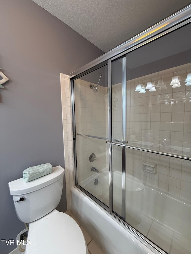 1209 Beechwood Dr, Johnson City, TN 37604 - bathroom featuring toilet, combined bath / shower with glass door, and a textured ceiling