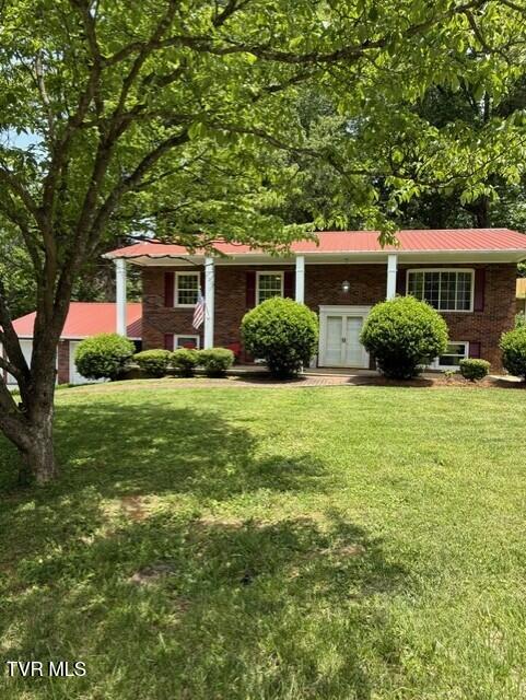 1209 Beechwood Dr, Johnson City, TN 37604 - view of front of house with a front lawn, metal roof, and brick siding