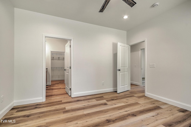 703 Swadley Rd, Johnson City, TN 37601 - unfurnished bedroom featuring light wood-style floors, baseboards, recessed lighting, and a walk in closet