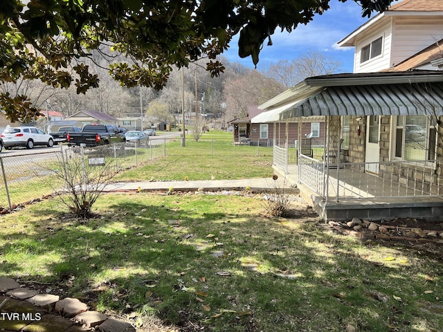 view of yard with fence and a porch