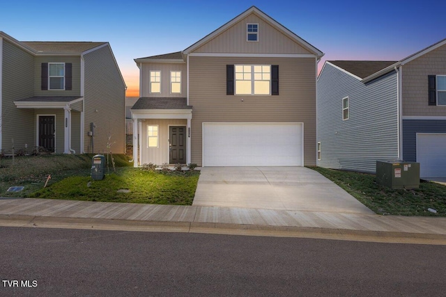 view of front facade featuring board and batten siding, driveway, a garage, and central AC