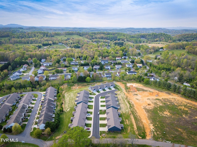 aerial view of property and surrounding area featuring nearby suburban area