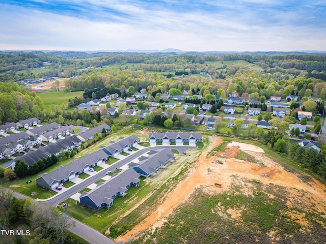 aerial view of property and surrounding area featuring nearby suburban area