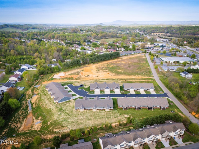 aerial overview of property's location with nearby suburban area and a mountainous background