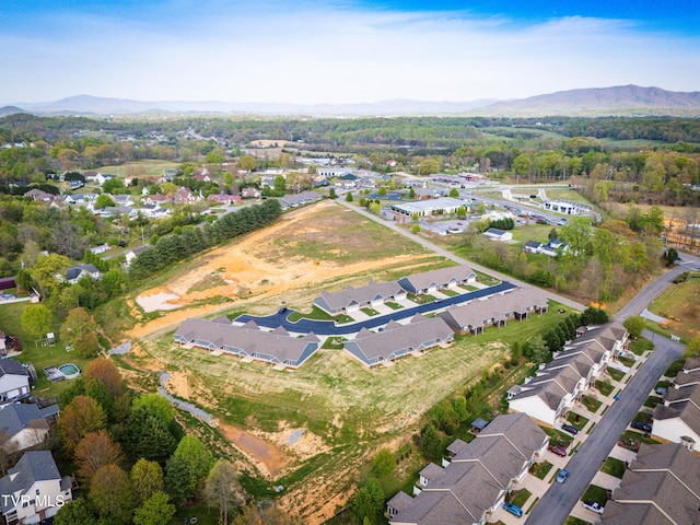 aerial view of property and surrounding area featuring mountains and nearby suburban area