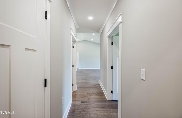 corridor with wood finished floors, baseboards, and recessed lighting