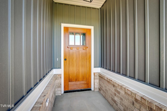 view of exterior entry with board and batten siding