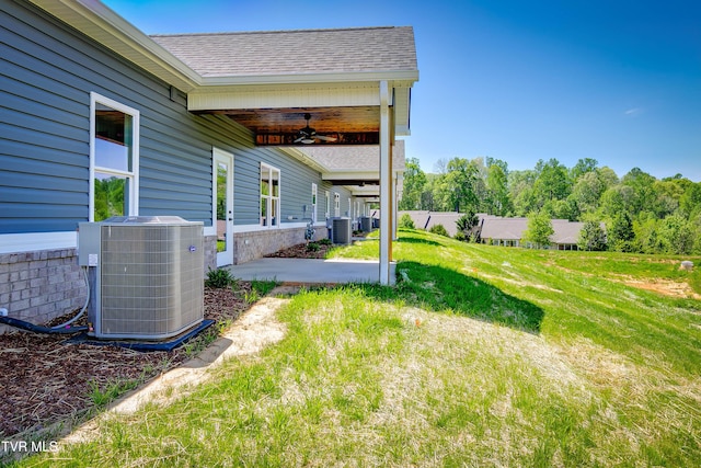 view of green lawn featuring cooling unit, a ceiling fan, and a patio area