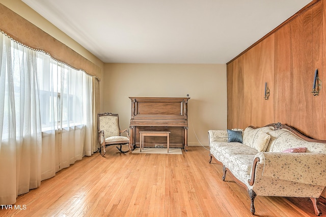 living area featuring baseboards and light wood-style flooring