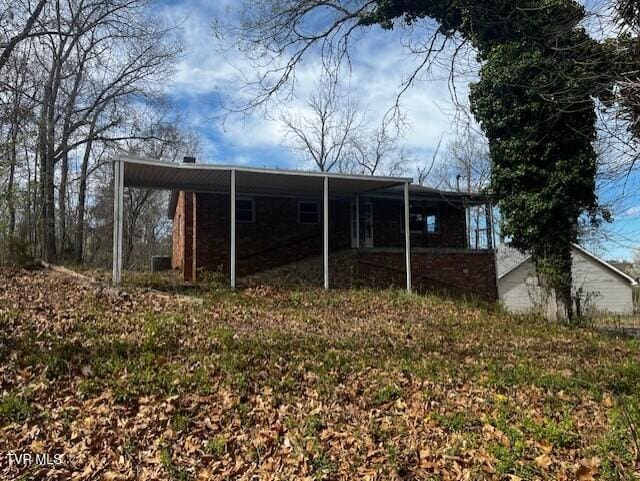 rear view of house with a carport