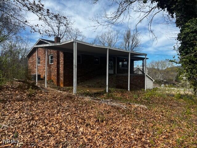 view of side of home with brick siding