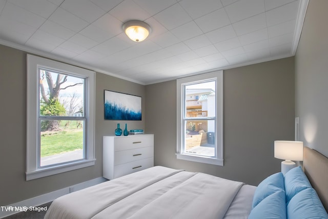 bedroom with crown molding and multiple windows
