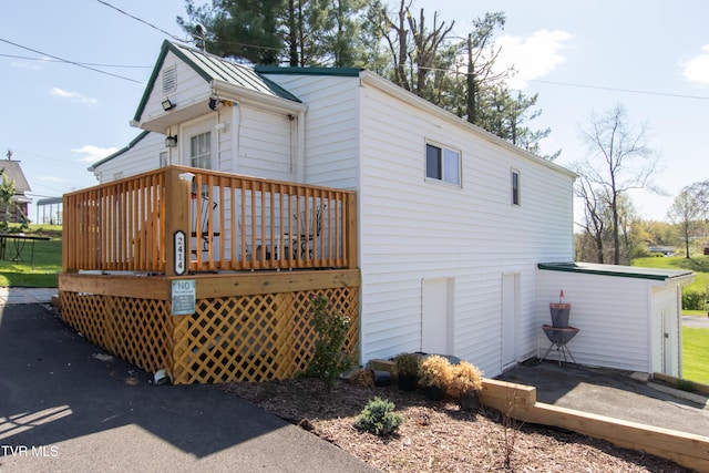 view of home's exterior featuring a wooden deck