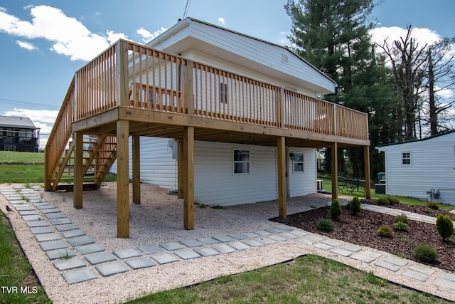 back of property with a deck and stairway