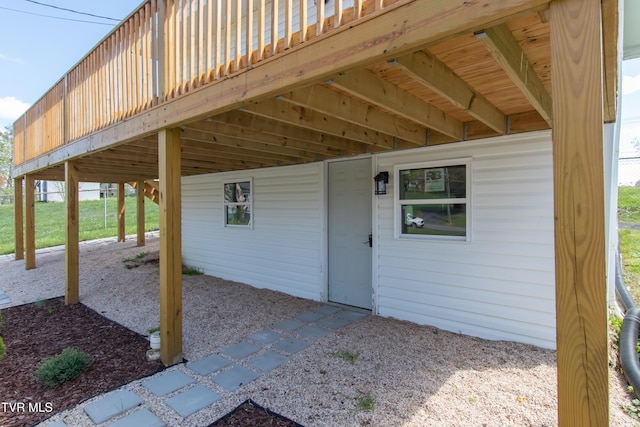 exterior space with a wooden deck and a carport