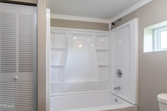 bathroom featuring shower / bathtub combination, toilet, and ornamental molding