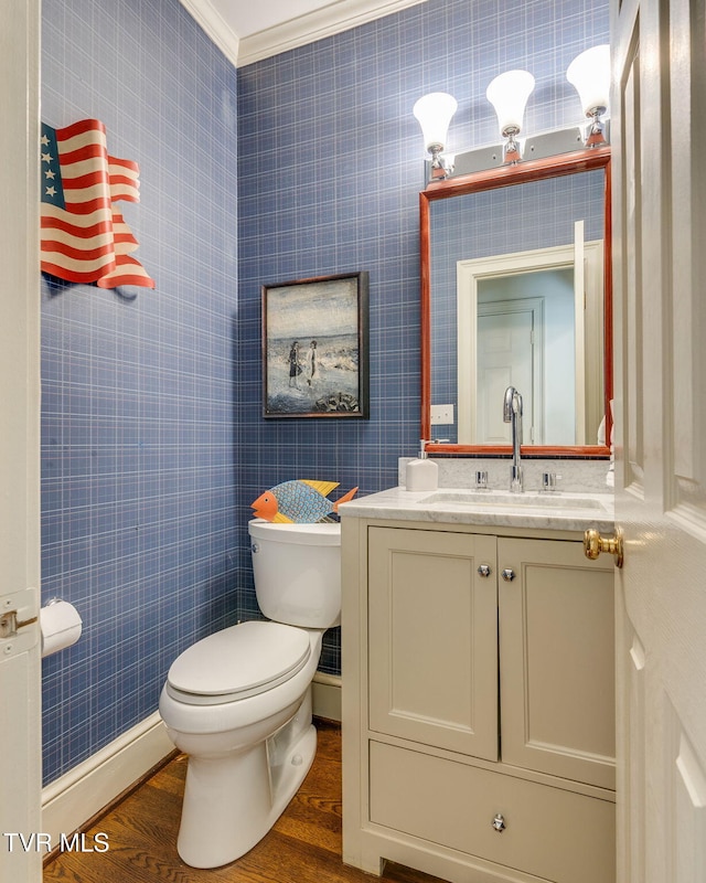 1221 Radcliffe Ave, Kingsport, TN 37664 - half bathroom with vanity, toilet, ornamental molding, baseboards, and wood finished floors