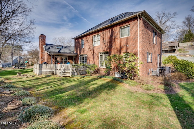 1221 Radcliffe Ave, Kingsport, TN 37664 - back of property with a chimney, a wooden deck, brick siding, and a yard