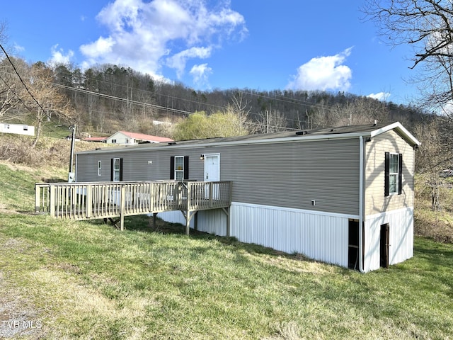 13 Woods Rd, Castlewood, VA 24224 - back of house with a forest view, a wooden deck, and a yard