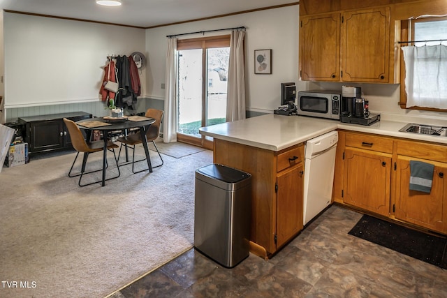 118 Starlite Dr, Greeneville, TN 37743 - kitchen with light countertops, ornamental molding, stainless steel appliances, a peninsula, and brown cabinetry