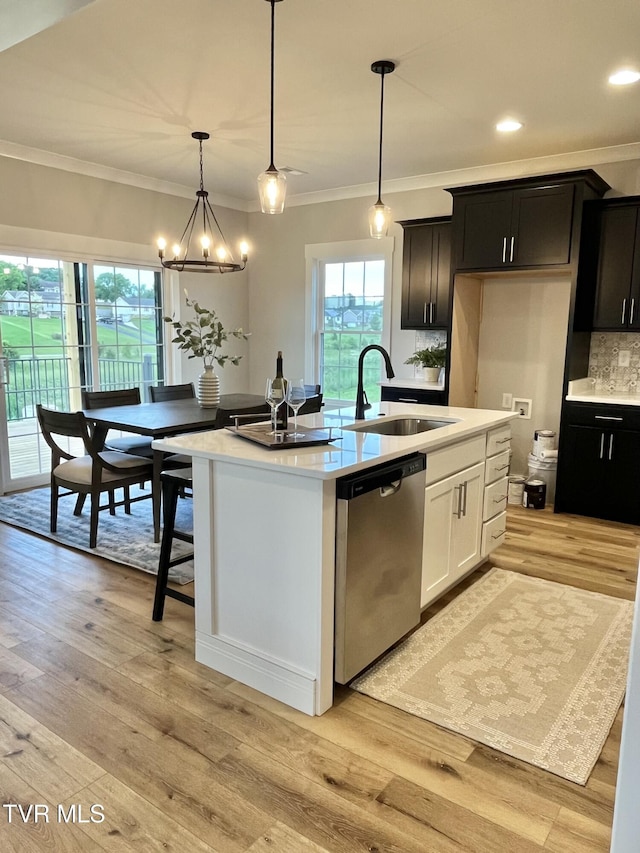 1270 Cabot Cv, Jonesborough, TN 37659 - kitchen with stainless steel dishwasher, a sink, crown molding, light countertops, and decorative backsplash