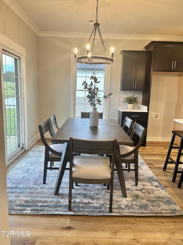 1270 Cabot Cv, Jonesborough, TN 37659 - dining room with a chandelier, healthy amount of natural light, ornamental molding, and light wood-type flooring