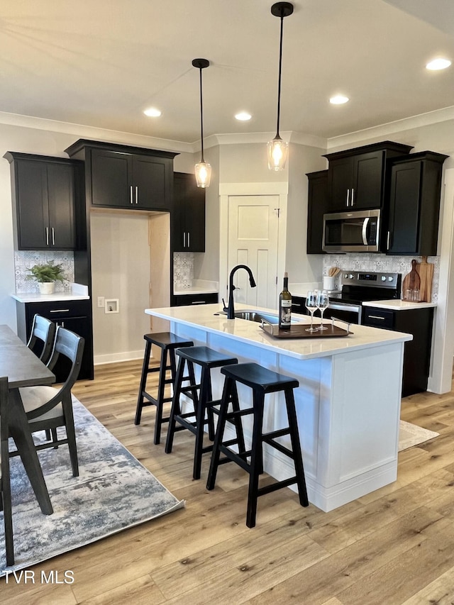 1270 Cabot Cv, Jonesborough, TN 37659 - kitchen with appliances with stainless steel finishes, dark cabinetry, a sink, ornamental molding, and tasteful backsplash