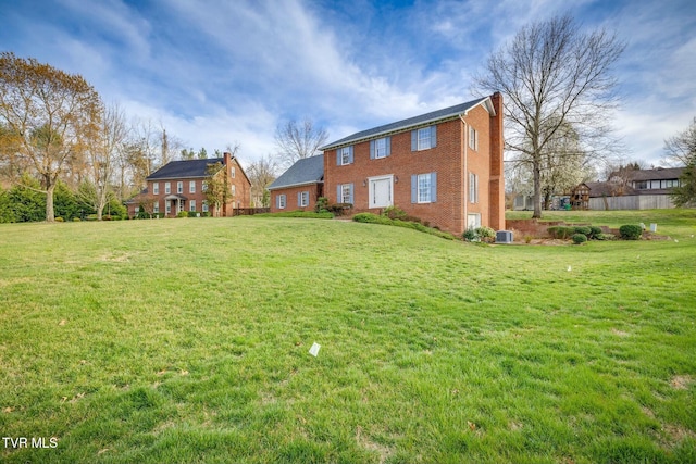 2017 Springfield Ave, Kingsport, TN 37664 - back of house featuring a lawn, a chimney, and brick siding