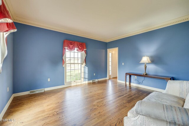 2017 Springfield Ave, Kingsport, TN 37664 - living area with baseboards, visible vents, crown molding, and wood finished floors