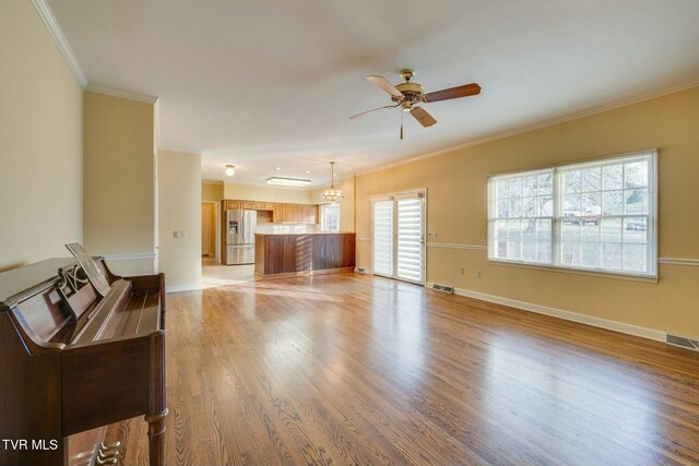 2017 Springfield Ave, Kingsport, TN 37664 - living area featuring baseboards, visible vents, light wood-style floors, ceiling fan, and ornamental molding